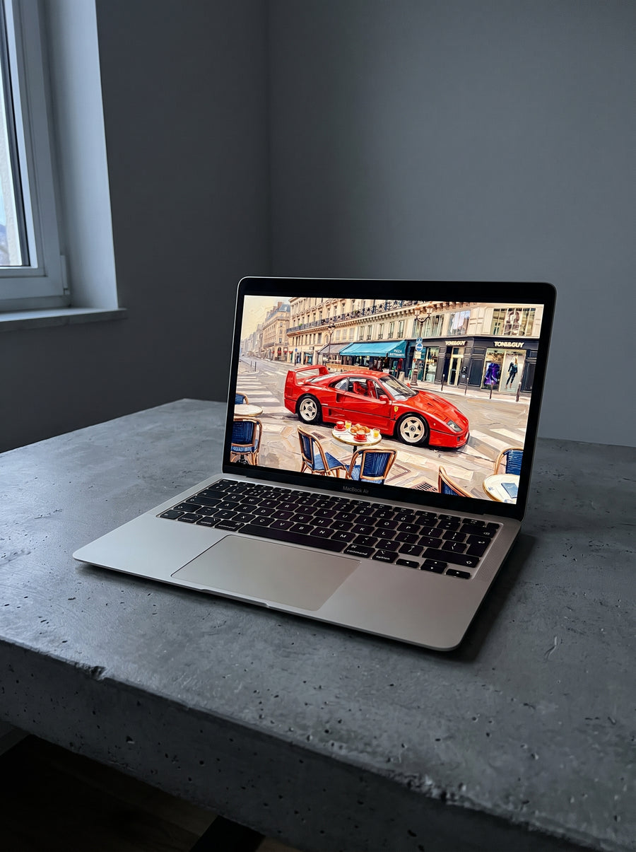 Vellum wallpaper on a MacBook Air on a concrete desk