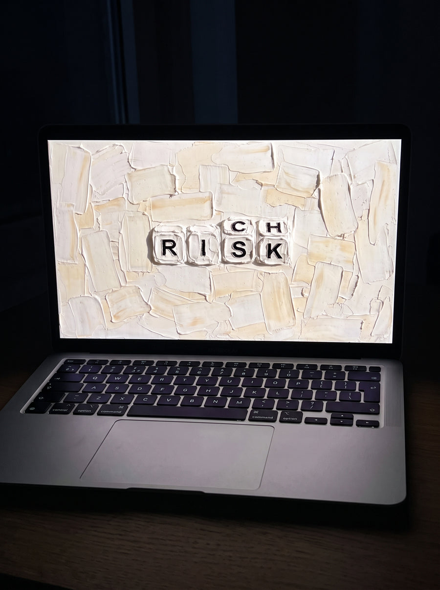 Vellum wallpaper on a MacBook Air on a wooden desk at night